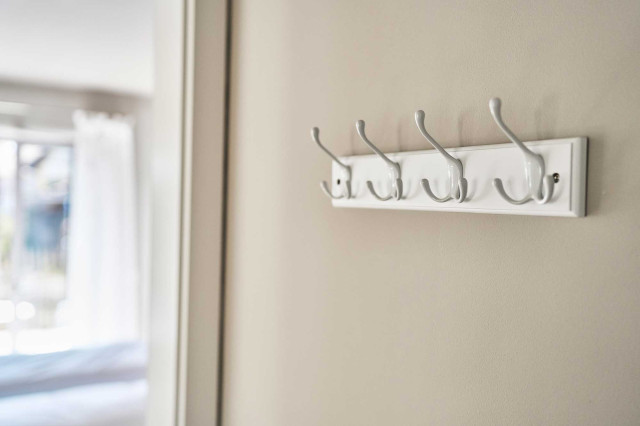 Das Flachshaus Ferienhaus - Hellgraue Wand mit weißer Garderobenhaken-Leiste (Photo 46)