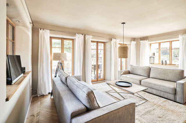 Das Flachshaus Ferienhaus - Wohnzimmer mit zwei hellgrauen gegenüberstehenden Sofas (Photo 3)